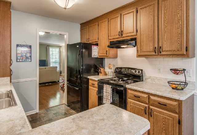 892 General George Patton Road, Unit 892 Nashville, TN 37221 - Photo 7 of 20 a kitchen with stainless steel appliances granite countertop a refrigerator stove and sink