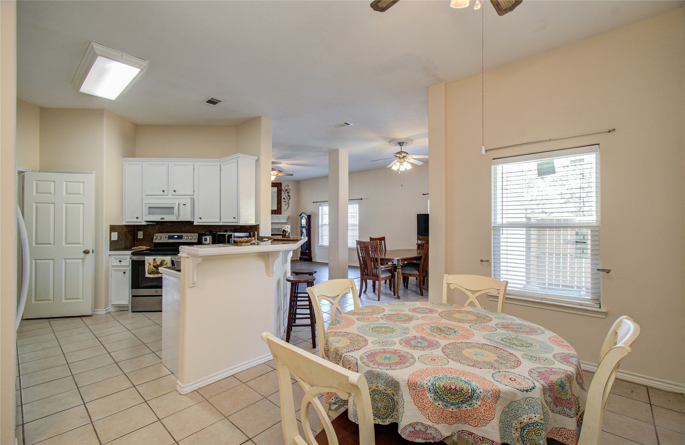 10822 Sail View Street Montgomery, TX 77356 - Photo 13 of 29 a kitchen with cabinets and chairs