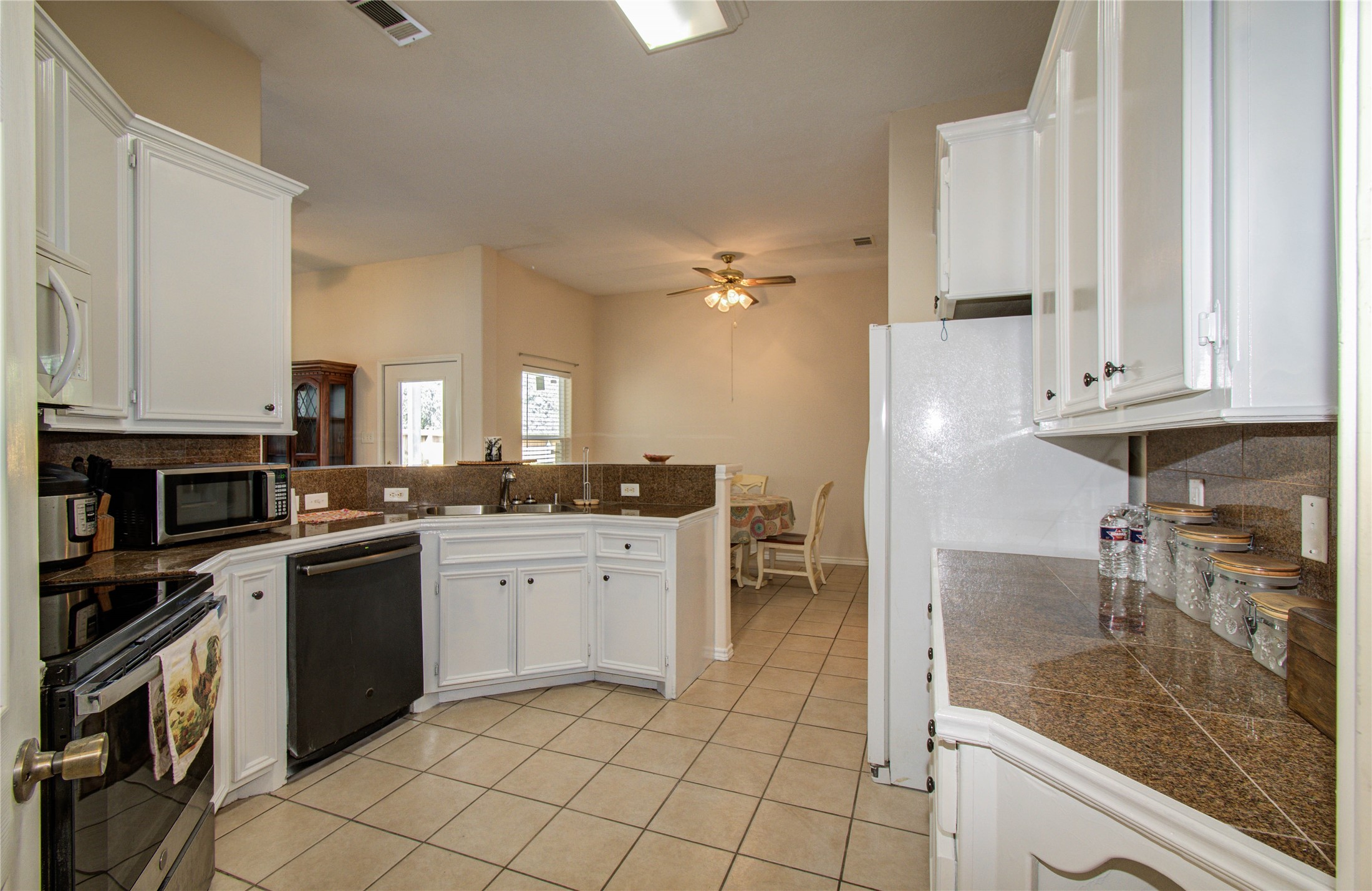 10822 Sail View Street Montgomery, TX 77356 - Photo 14 of 29 a kitchen with a sink and cabinets