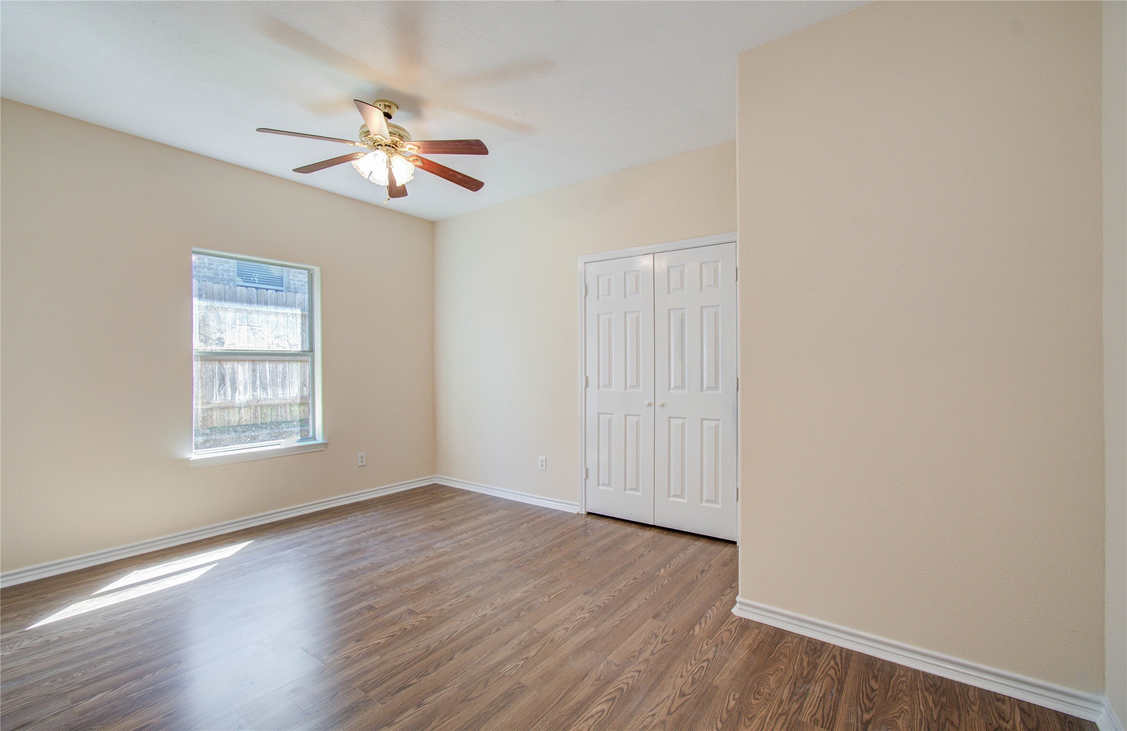 10822 Sail View Street Montgomery, TX 77356 - Photo 22 of 29 a view of an empty room with wooden floor and a window