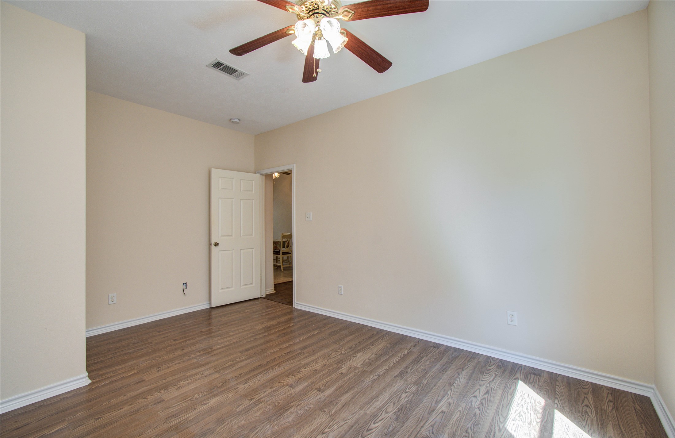 10822 Sail View Street Montgomery, TX 77356 - Photo 23 of 29 an empty room with wooden floor chandelier fan and closet area