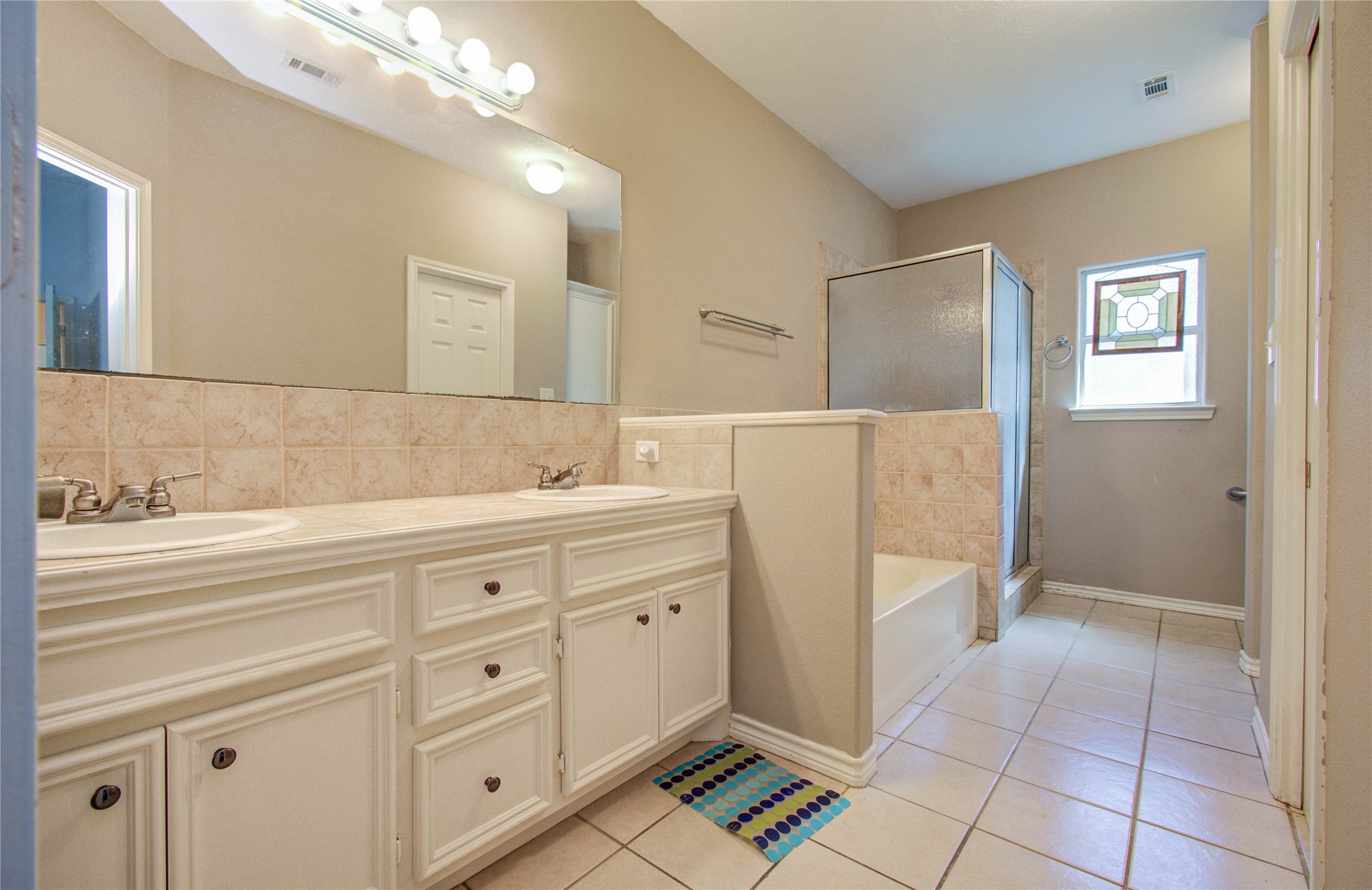 10822 Sail View Street Montgomery, TX 77356 - Photo 25 of 29 a spacious bathroom with a sink a mirror and a shower