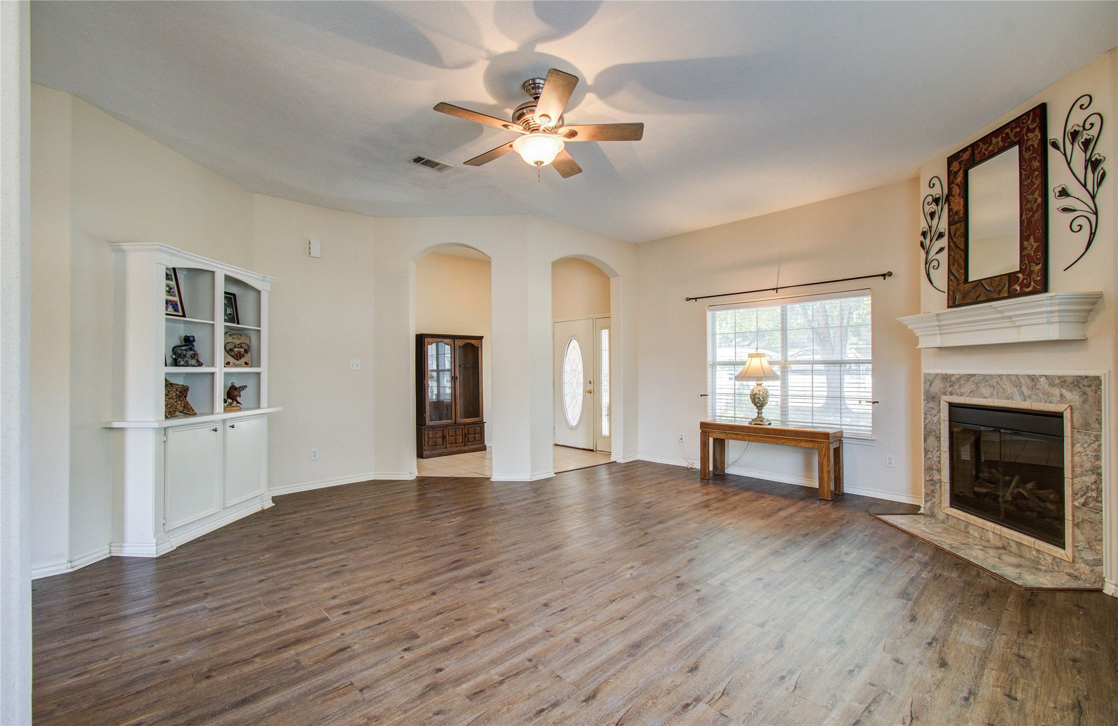 10822 Sail View Street Montgomery, TX 77356 - Photo 7 of 29 a view of a livingroom with a ceiling fan fireplace and wooden floor