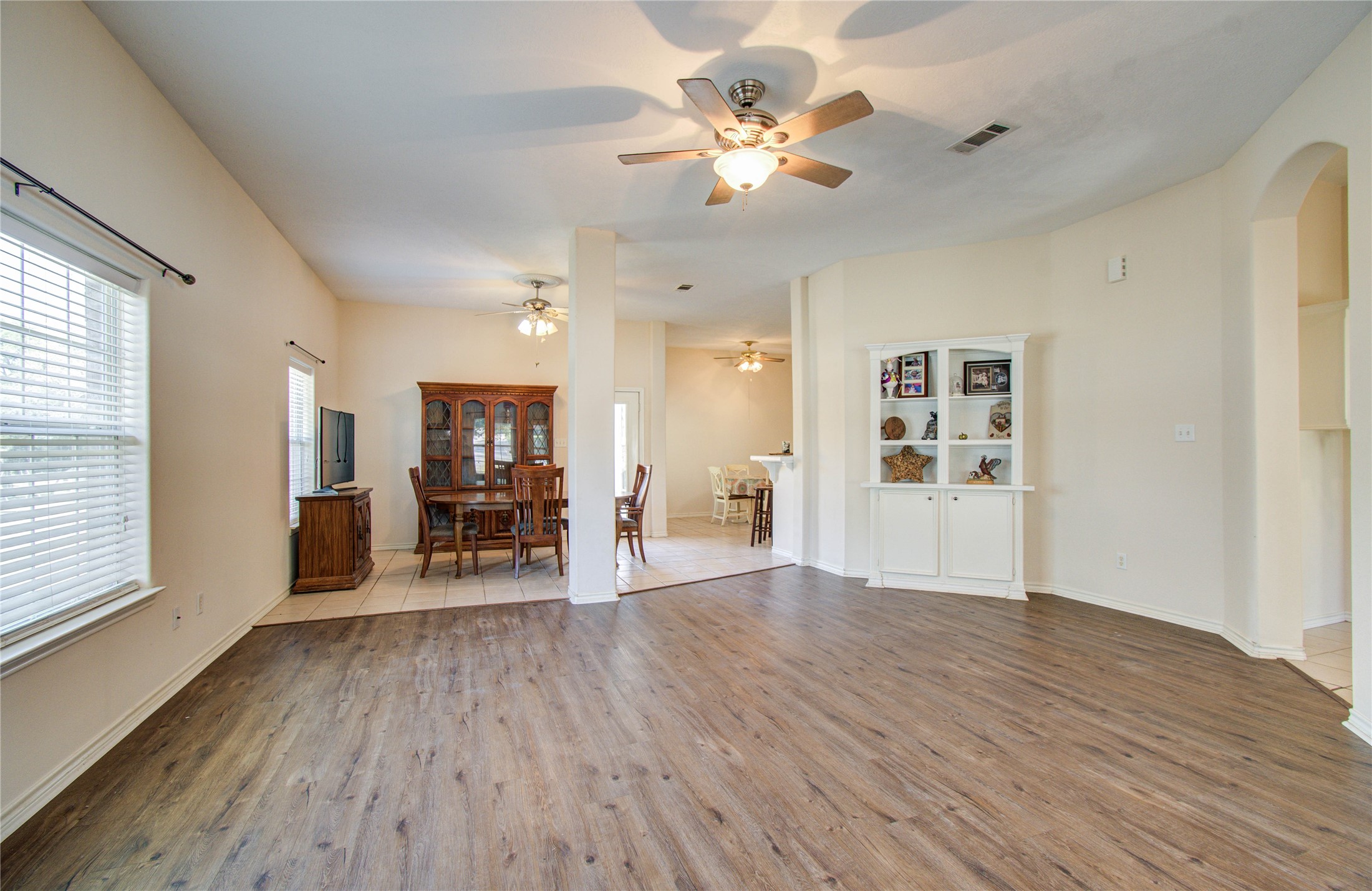 10822 Sail View Street Montgomery, TX 77356 - Photo 9 of 29 a view of a livingroom with wooden floor and a ceiling fan