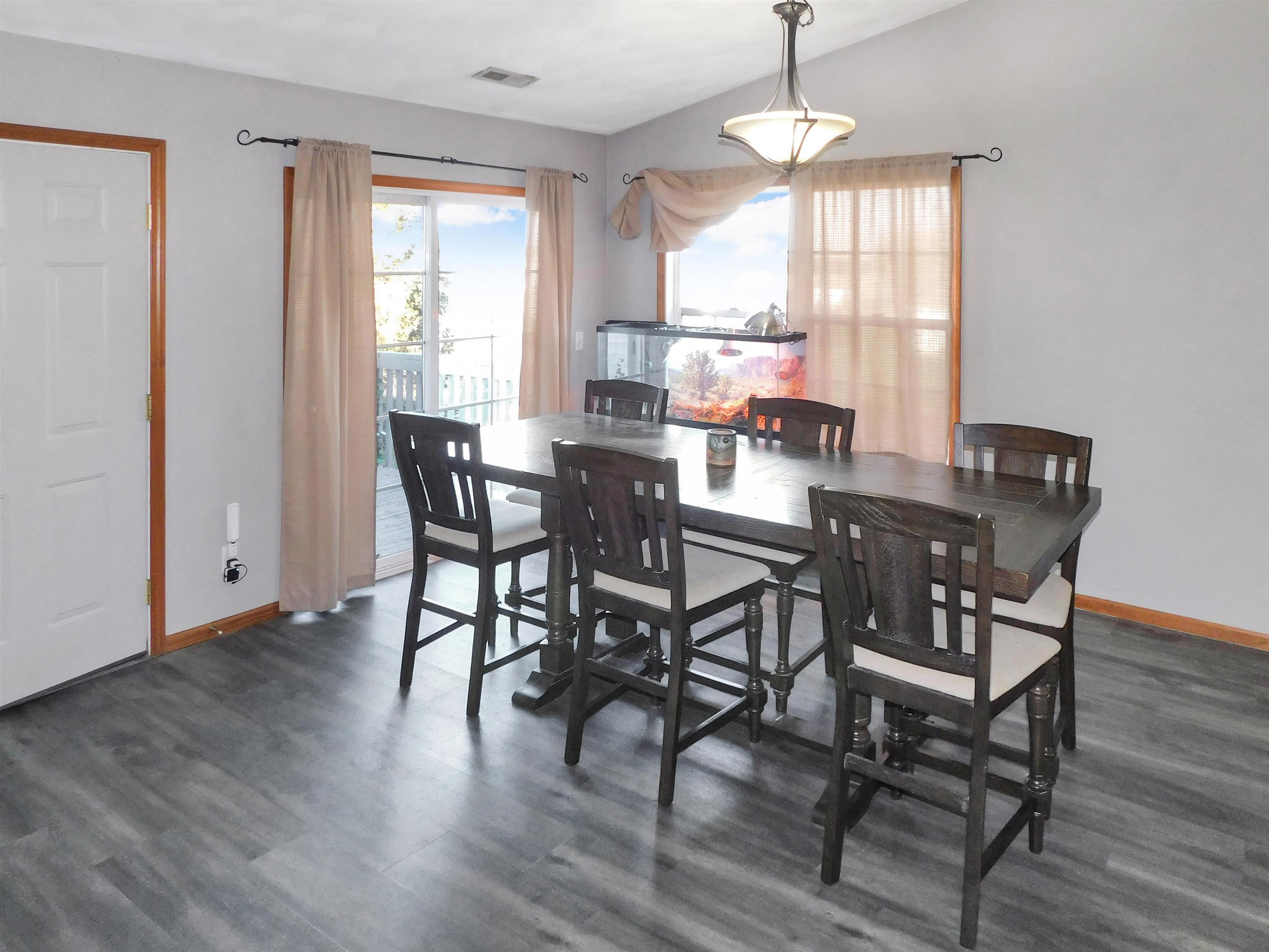 558 Mosaic Lane, Unit 1 Roscoe, IL 61073 - Photo 11 of 28 a view of a dining room with furniture window and wooden floor