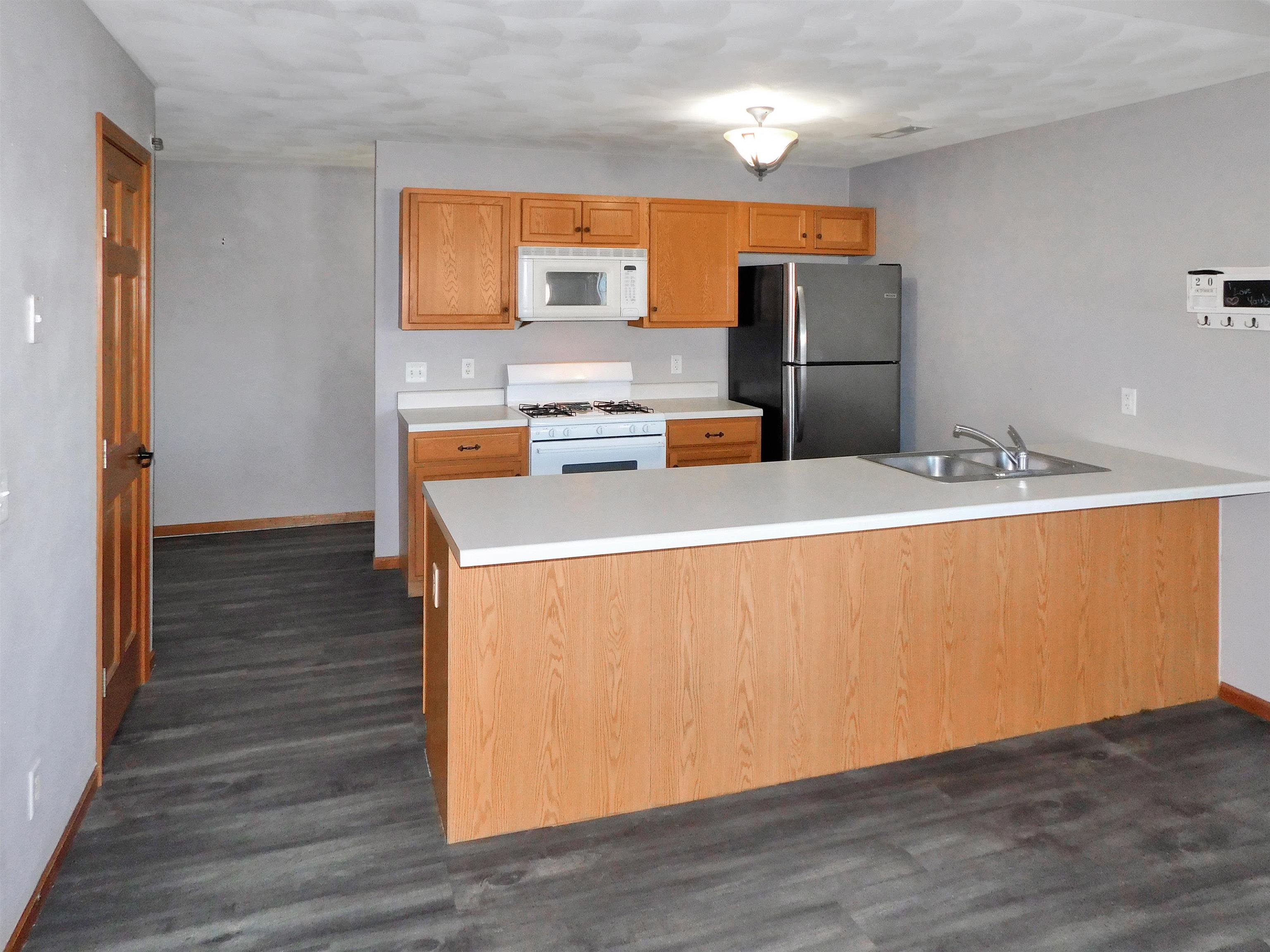558 Mosaic Lane, Unit 1 Roscoe, IL 61073 - Photo 12 of 28 a kitchen with stainless steel appliances a refrigerator and a stove