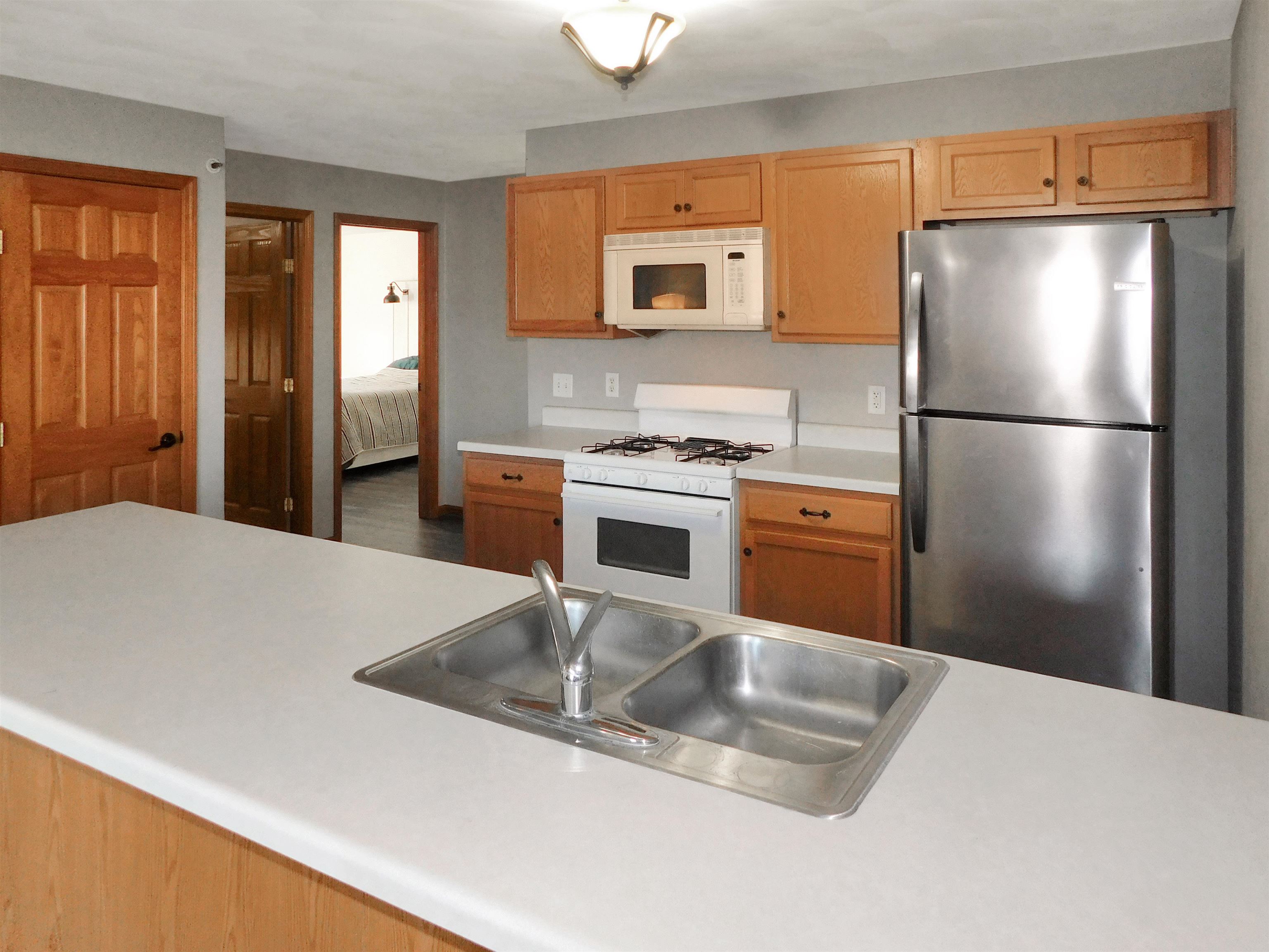 558 Mosaic Lane, Unit 1 Roscoe, IL 61073 - Photo 14 of 28 a kitchen with a refrigerator a stove top oven a sink and dishwasher