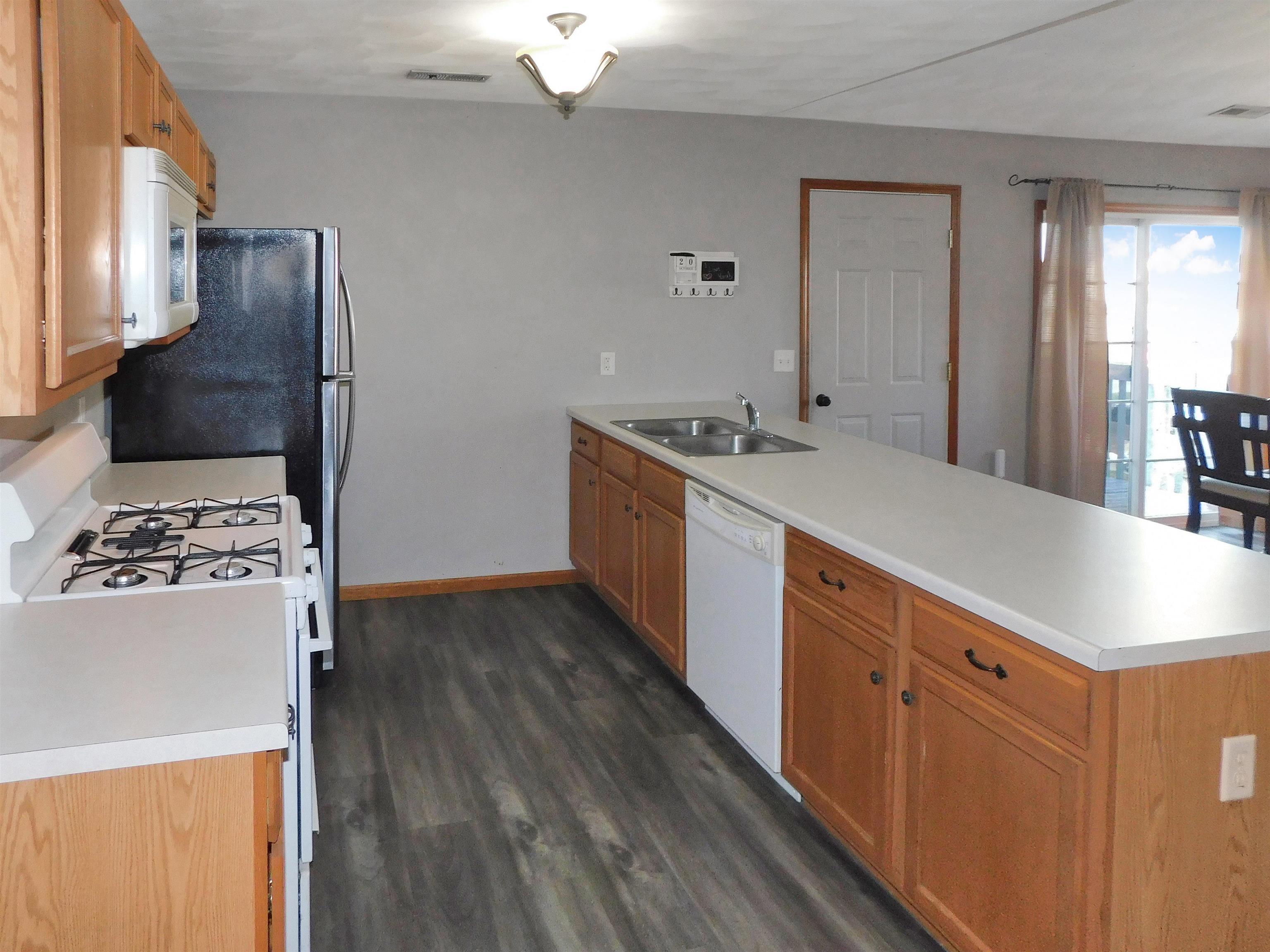 558 Mosaic Lane, Unit 1 Roscoe, IL 61073 - Photo 15 of 28 a kitchen with stainless steel appliances a stove refrigerator and a sink