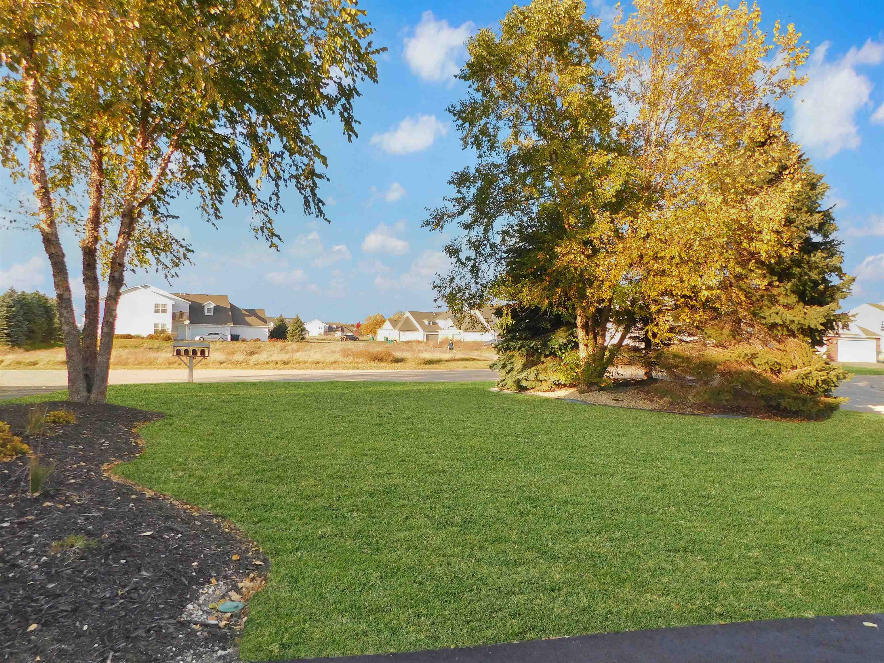 558 Mosaic Lane, Unit 1 Roscoe, IL 61073 - Photo 27 of 28 a view of a field with large trees