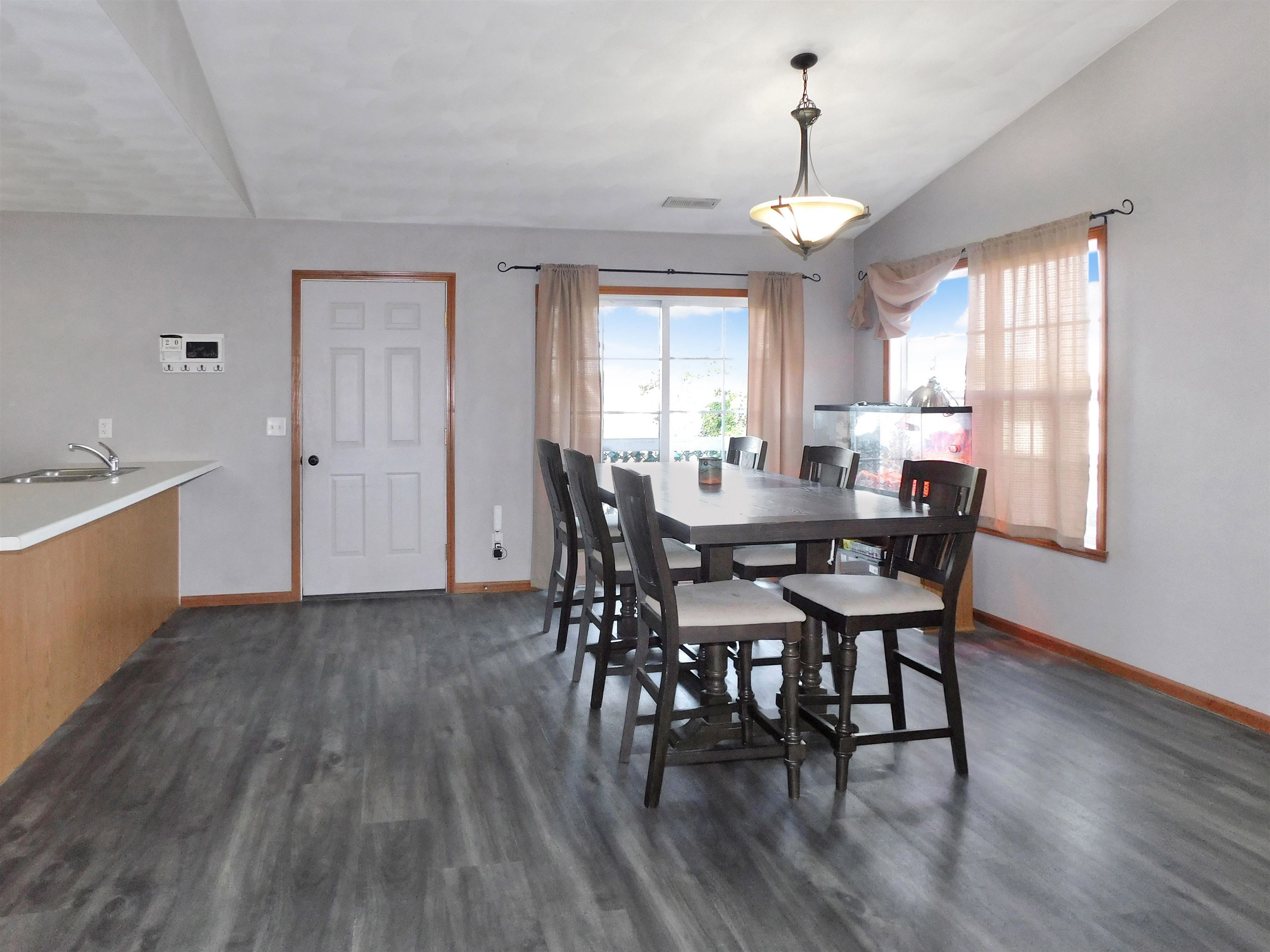 558 Mosaic Lane, Unit 1 Roscoe, IL 61073 - Photo 6 of 28 a view of a dining room with furniture window and wooden floor