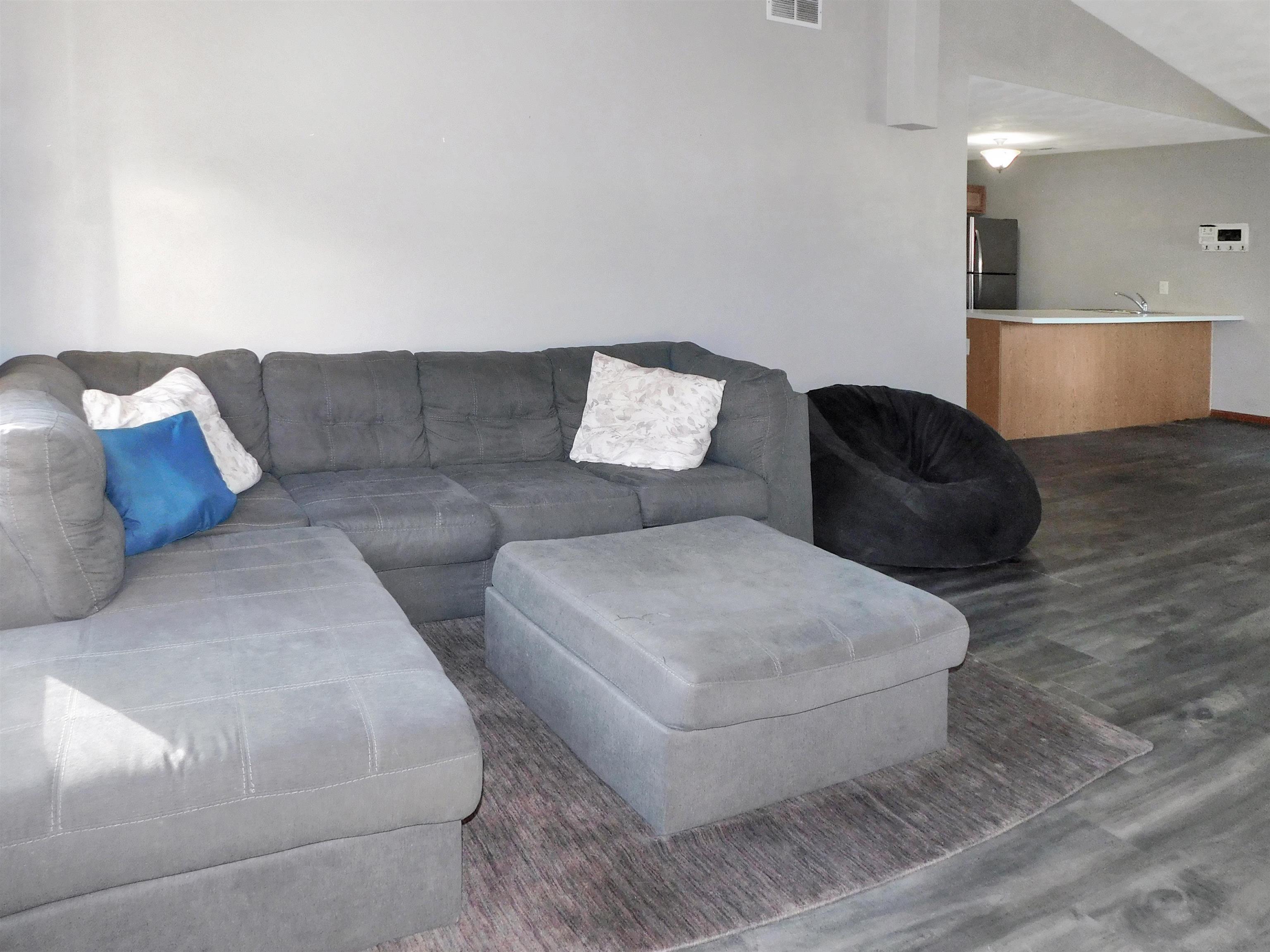 558 Mosaic Lane, Unit 1 Roscoe, IL 61073 - Photo 8 of 28 a living room with furniture and a couch