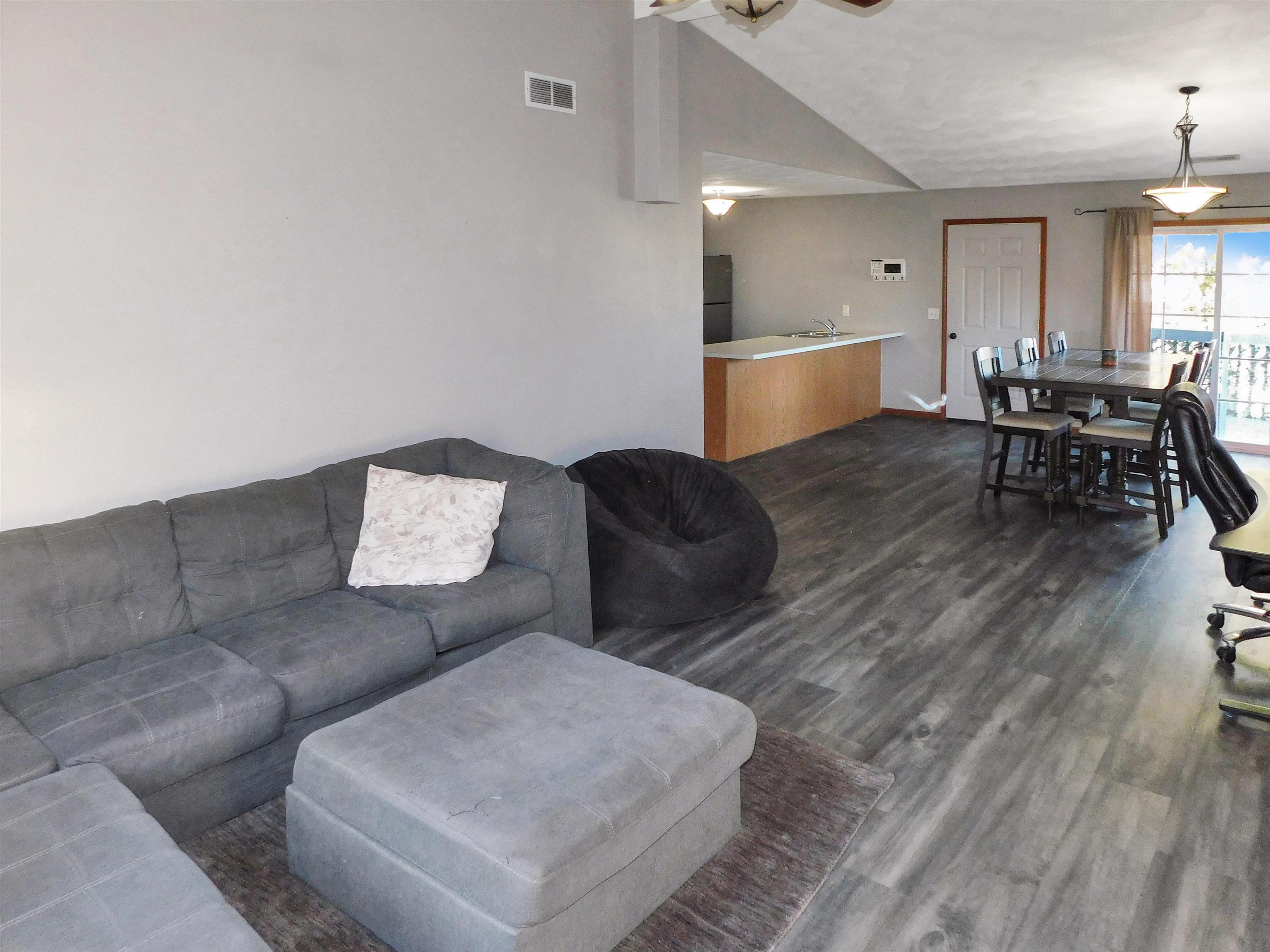 558 Mosaic Lane, Unit 1 Roscoe, IL 61073 - Photo 9 of 28 a living room with furniture and a table