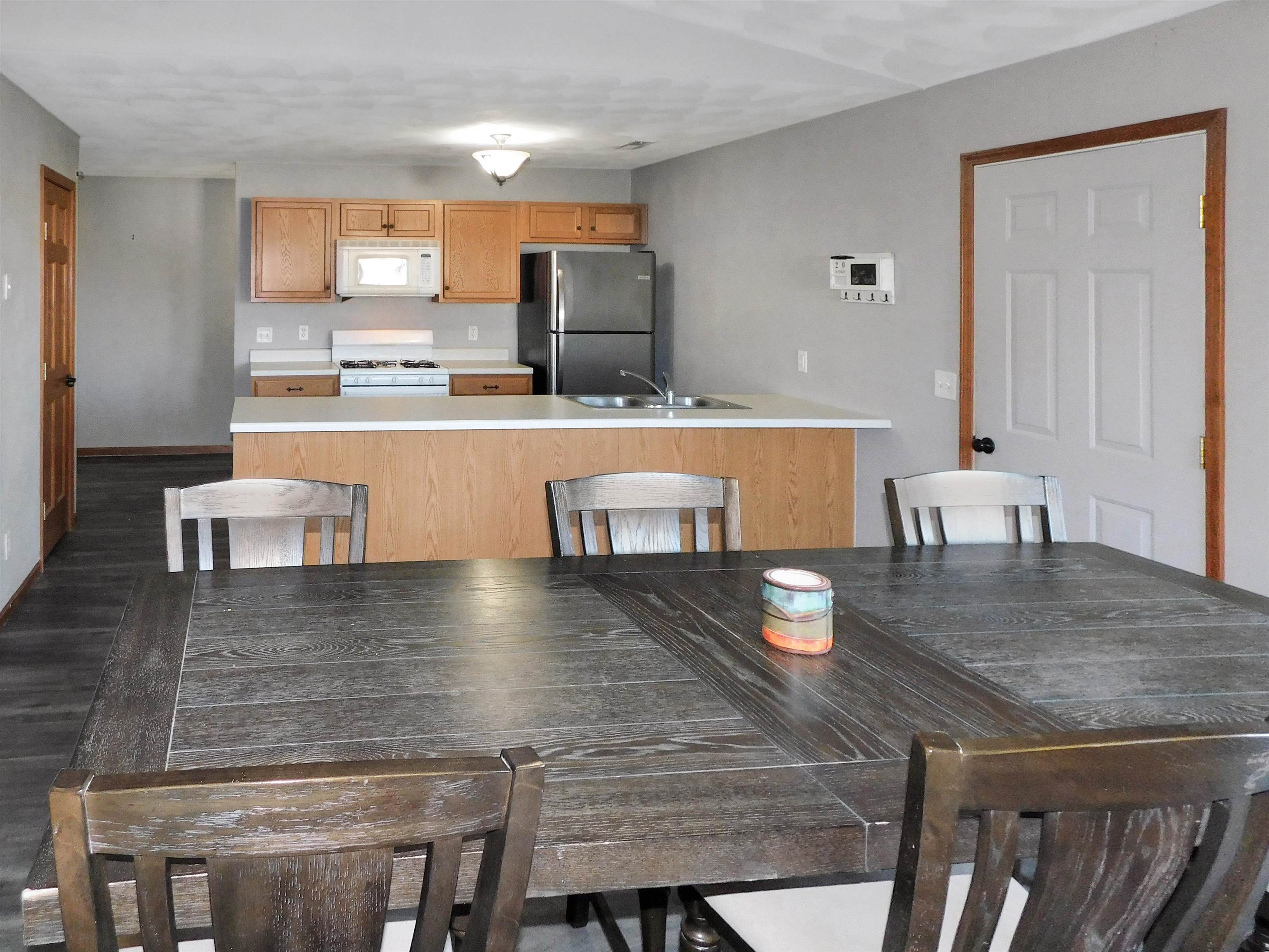 558 Mosaic Lane, Unit 1 Roscoe, IL 61073 - Photo 10 of 28 a kitchen with kitchen island a counter space and appliances in it