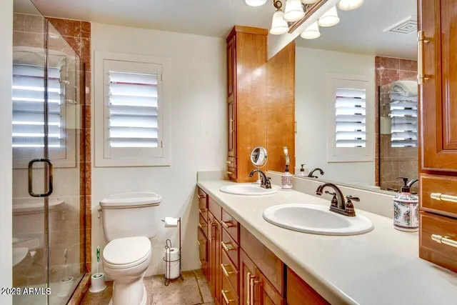 a bathroom with a sink toilet and shower