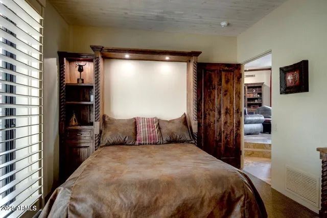 a bedroom with a large bed and a flat screen tv