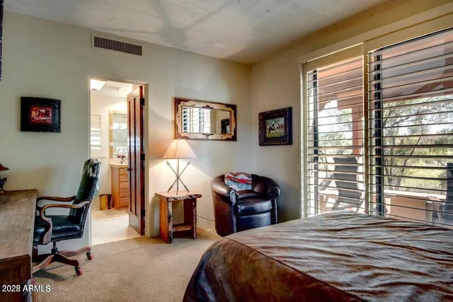 a bedroom with furniture and a window