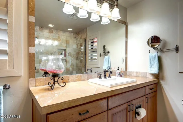 a bathroom with a sink a light fixture and a mirror
