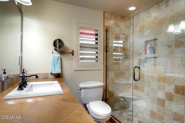 a bathroom with a sink toilet and shower