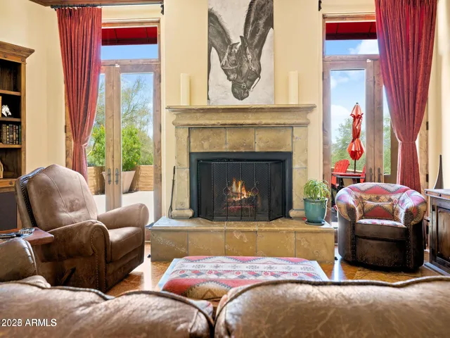 a bedroom with a bed a fireplace and a large window