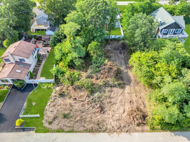 an aerial view of a house with a yard basket ball court and outdoor seating