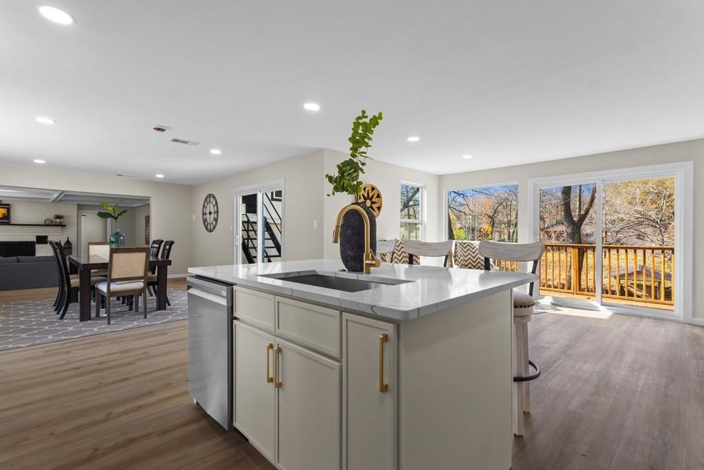 2155 Hickory Trace Mabank, TX 75156 - Photo 14 of 40 a room with stainless steel appliances granite countertop a dining table chairs and couches with wooden floor