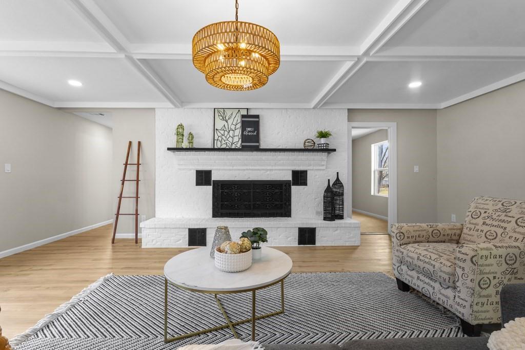 2155 Hickory Trace Mabank, TX 75156 - Photo 24 of 40 a living room with furniture a chandelier and a fireplace