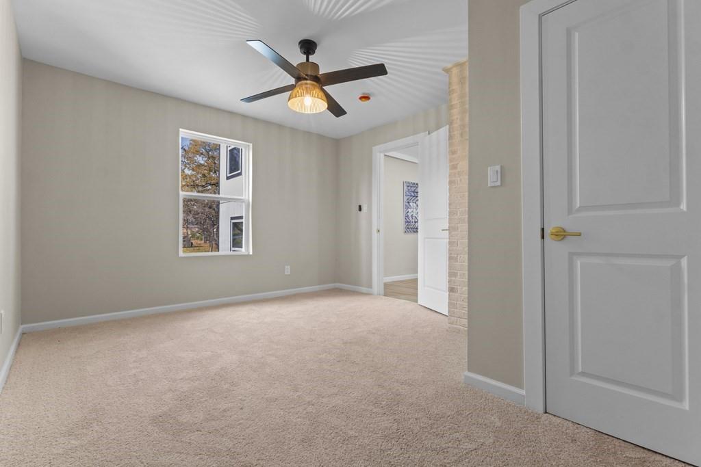 2155 Hickory Trace Mabank, TX 75156 - Photo 31 of 40 an empty room with windows and fan