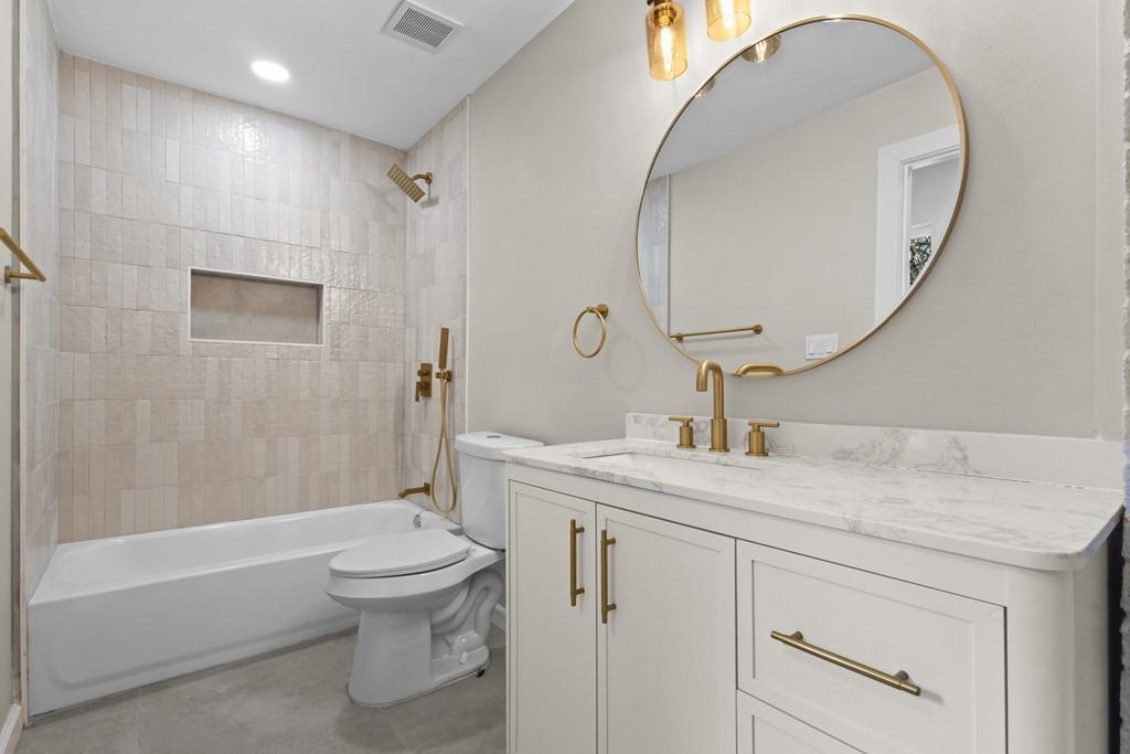 2155 Hickory Trace Mabank, TX 75156 - Photo 32 of 40 a bathroom with a sink a toilet and a mirror