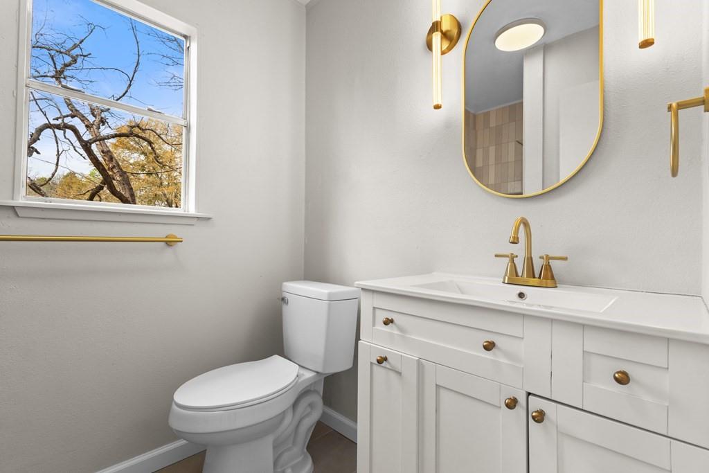 2155 Hickory Trace Mabank, TX 75156 - Photo 35 of 40 a bathroom with a toilet sink and mirror