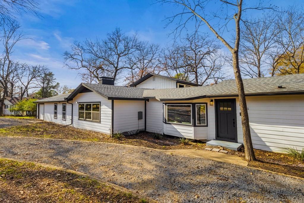 2155 Hickory Trace Mabank, TX 75156 - Photo 5 of 40 a house that has a tree in front of the house