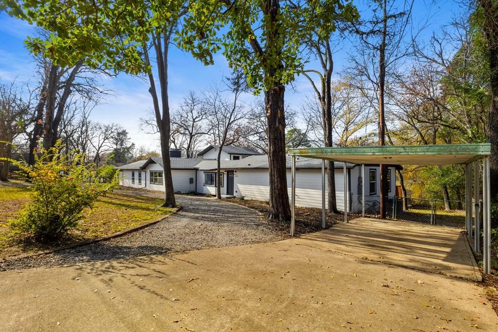 2155 Hickory Trace Mabank, TX 75156 - Photo 8 of 40 a front view of a house with a yard and tree s