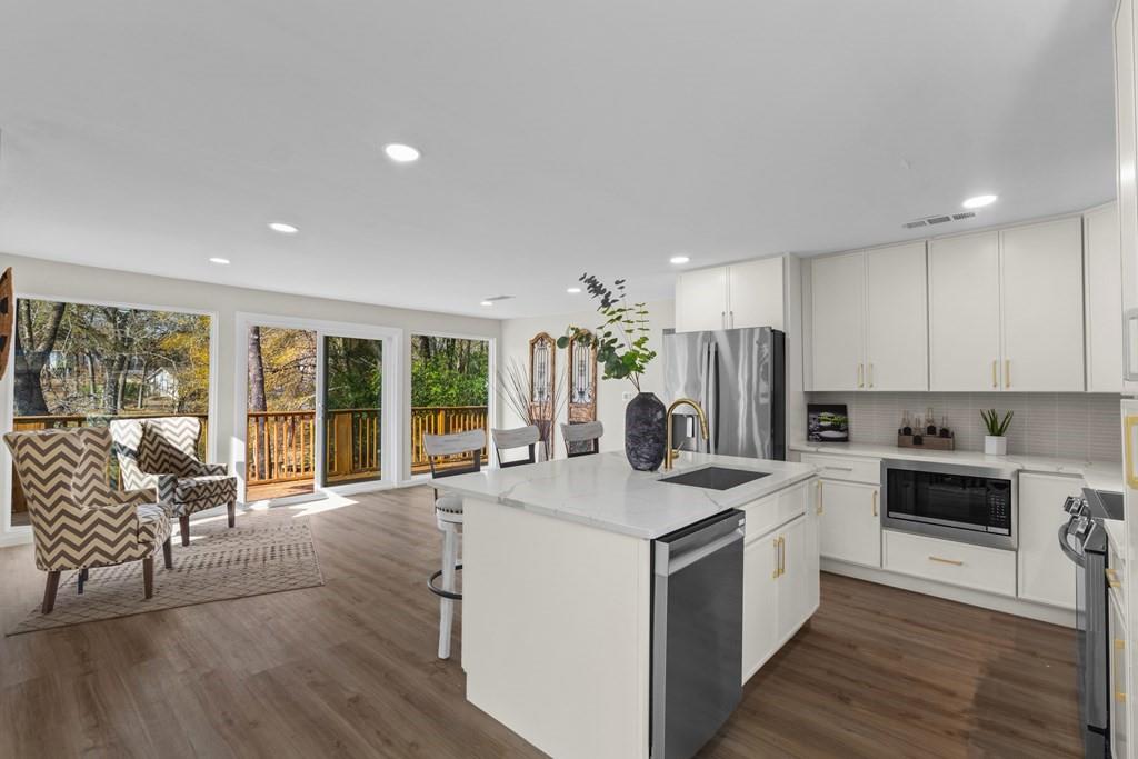 2155 Hickory Trace Mabank, TX 75156 - Photo 9 of 40 a kitchen with sink a stove and refrigerator