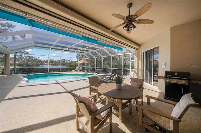 a view of a hallway to a room with windows