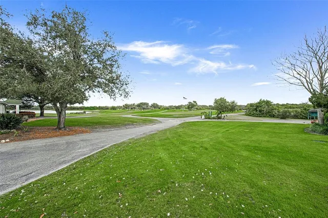 an aerial view of a golf course with swimming pool