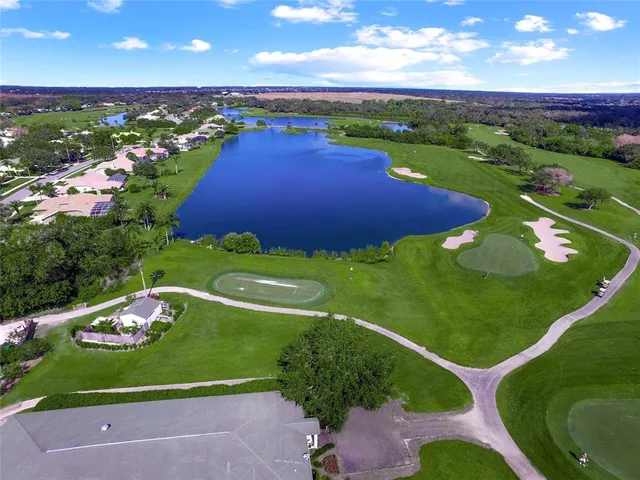 a front view of a house with a garden and trees