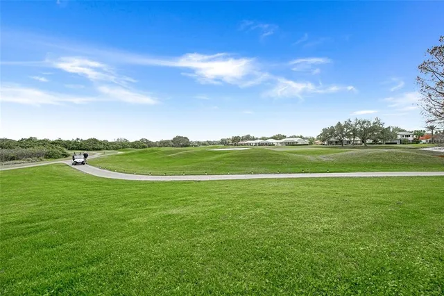 a front view of a house with garden and trees