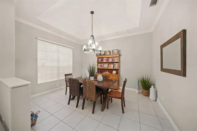 a kitchen with stainless steel appliances a stove a sink a refrigerator white cabinets and a refrigerator