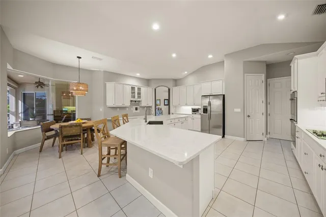a kitchen with sink and white cabinets