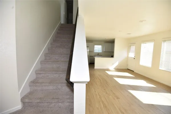 a view of entryway and hall with wooden floor