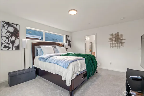 a bedroom with a large bed and a large window