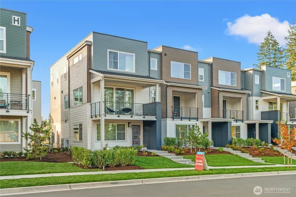 a front view of a residential apartment building with a yard