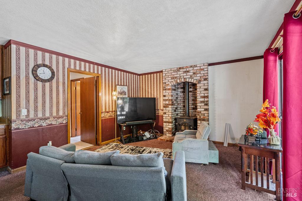 715 Placer Court Santa Rosa, CA 95401 - Photo 13 of 37 a living room with furniture a flat screen tv and a window