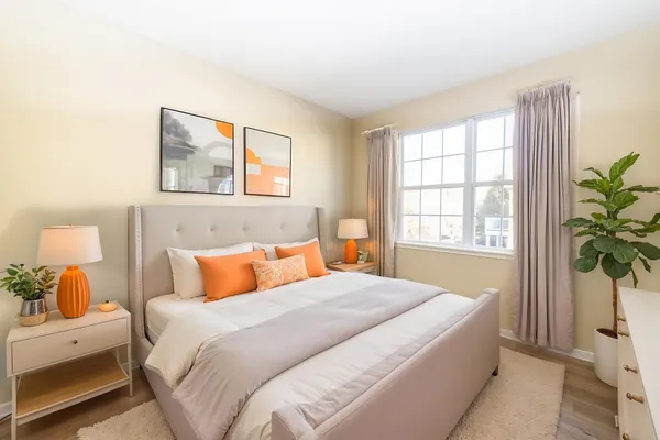 a bedroom with a bed and a window