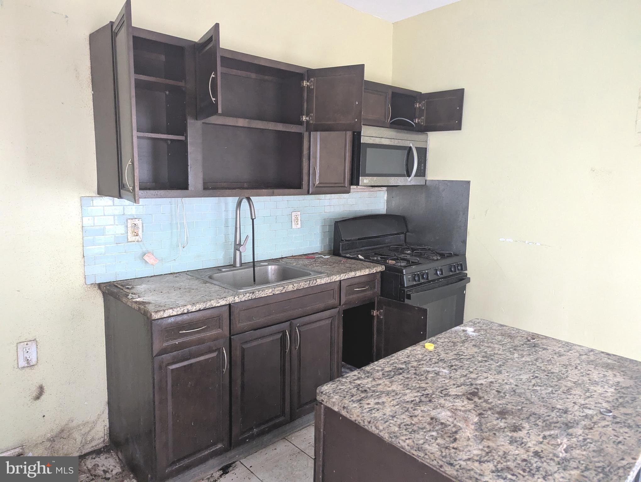 3838 Cambridge Street Philadelphia, PA 19104 - Photo 9 of 10 a kitchen with a sink and cabinets