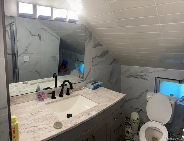 a bathroom with a sink toilet and mirror