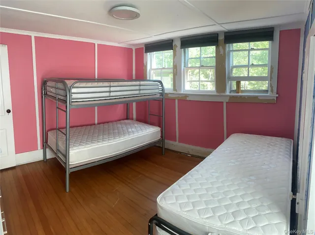 a bedroom with bed and window