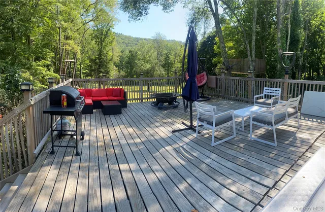 a view of a wooden deck with furniture