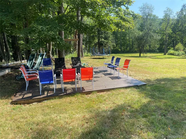 a backyard of a house with table and chairs