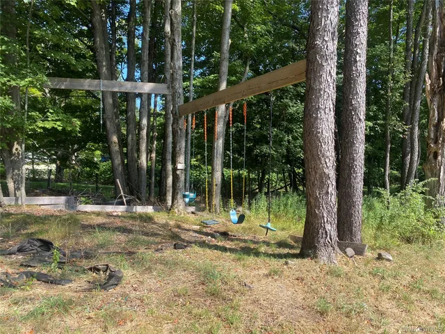 a backyard of a house with lots of green space and seating space