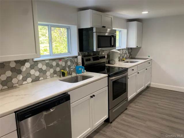 a kitchen with a sink stove and microwave